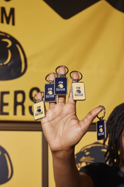 Cool “Gym Sisters” keyrings on every finger of an influencer’s hand.