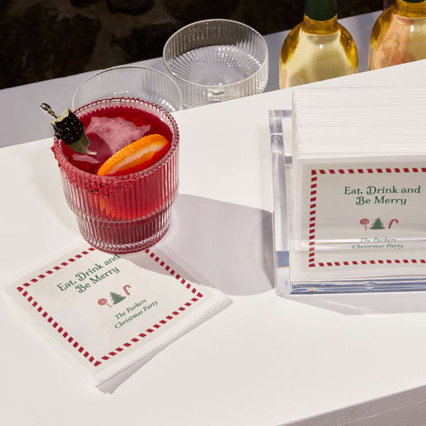 A custom napkin that says &ldquo;Eat, Drink and Be Merry,&rdquo; &ldquo;The Parkers Christmas Party&rdquo;