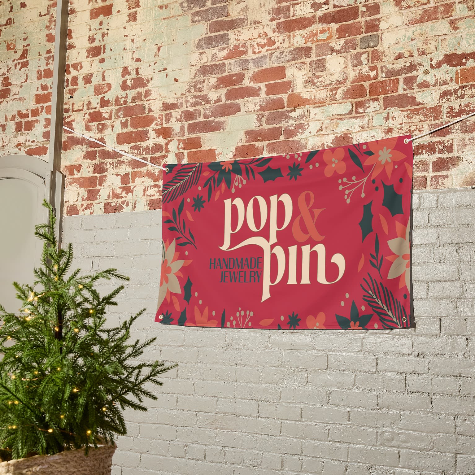A festive banner sign on a brick wall