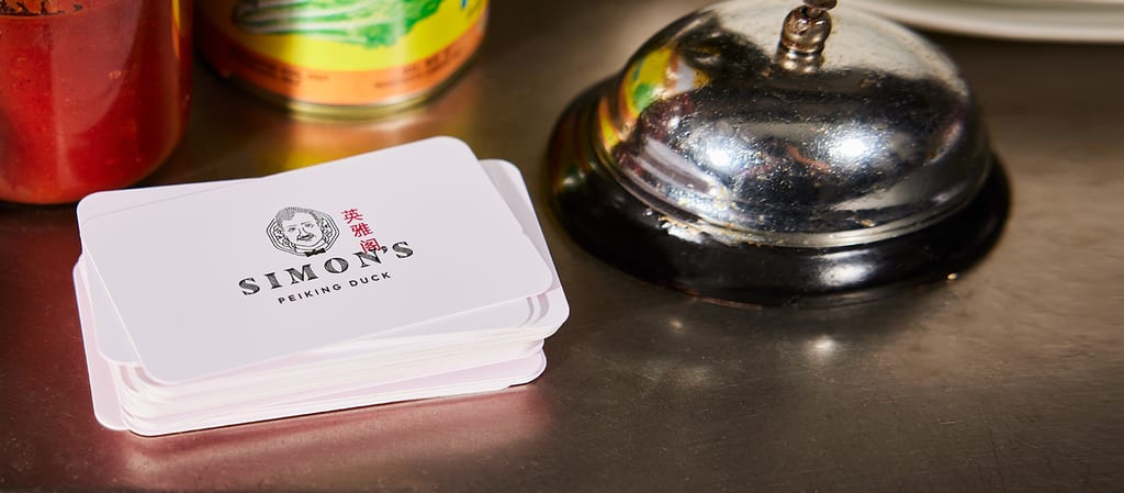 A white business card on a recycled paper stock