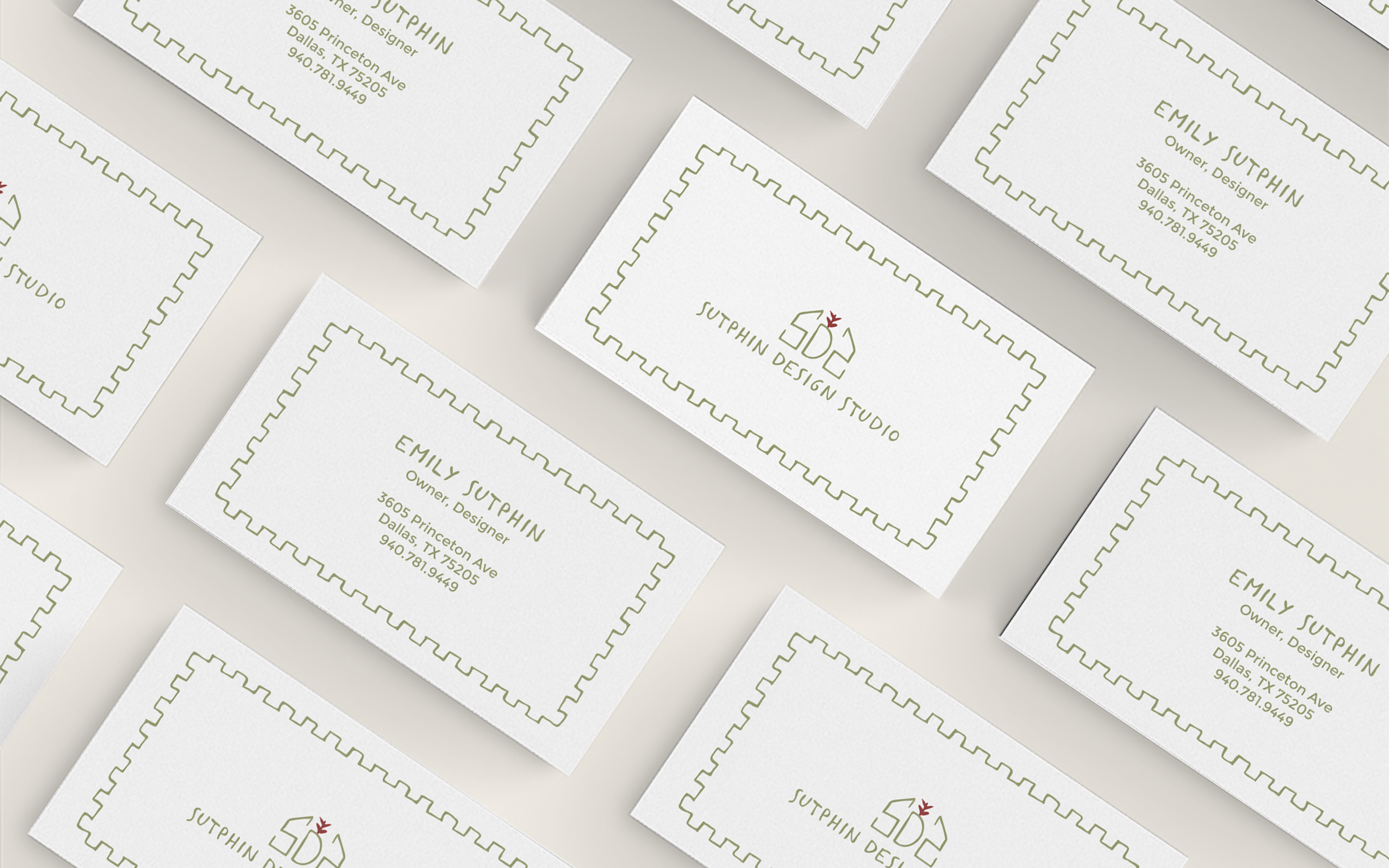 white business card with green text in a custom font