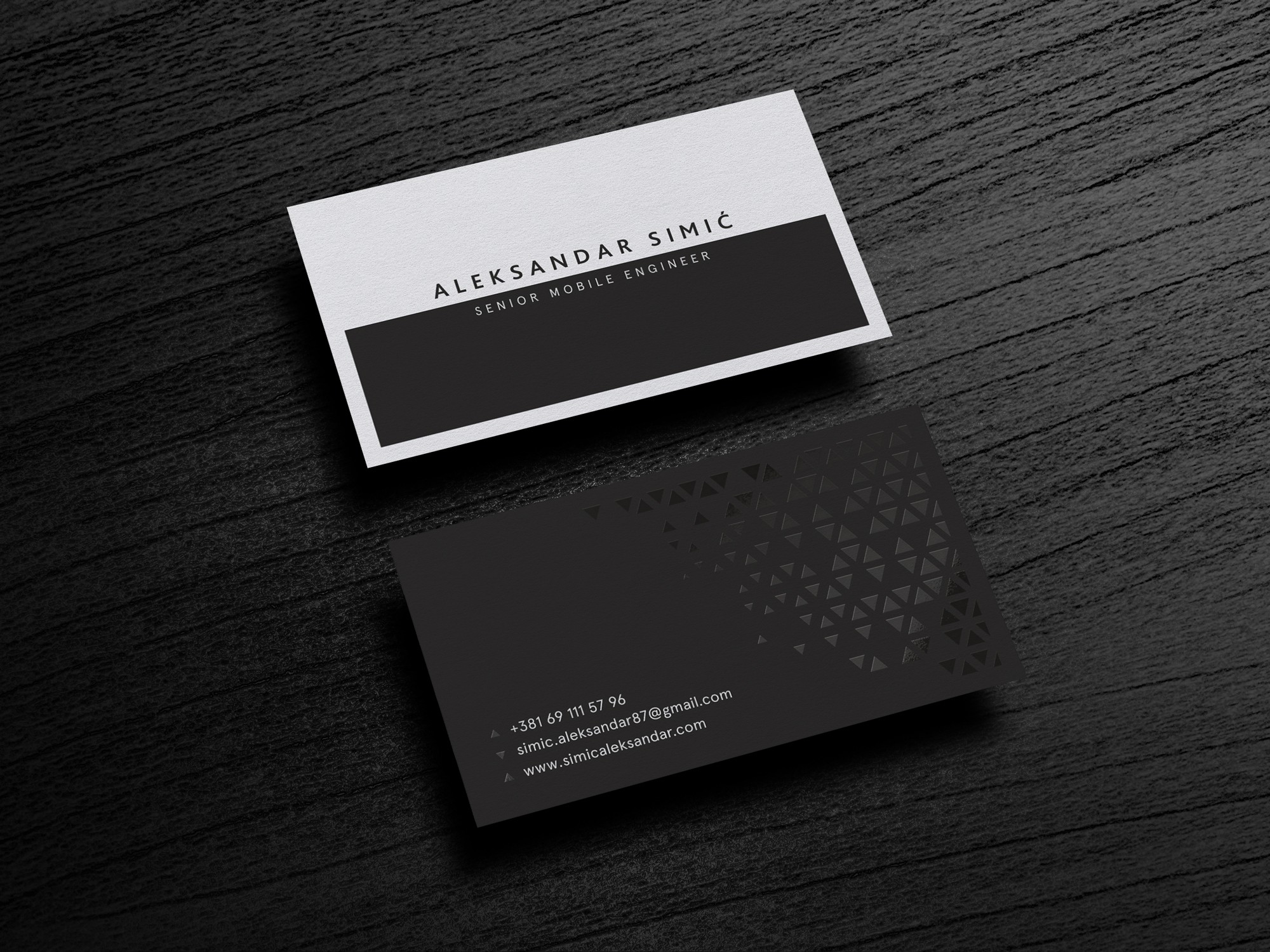 all-black matte business card with a pattern made of glossy triangles
