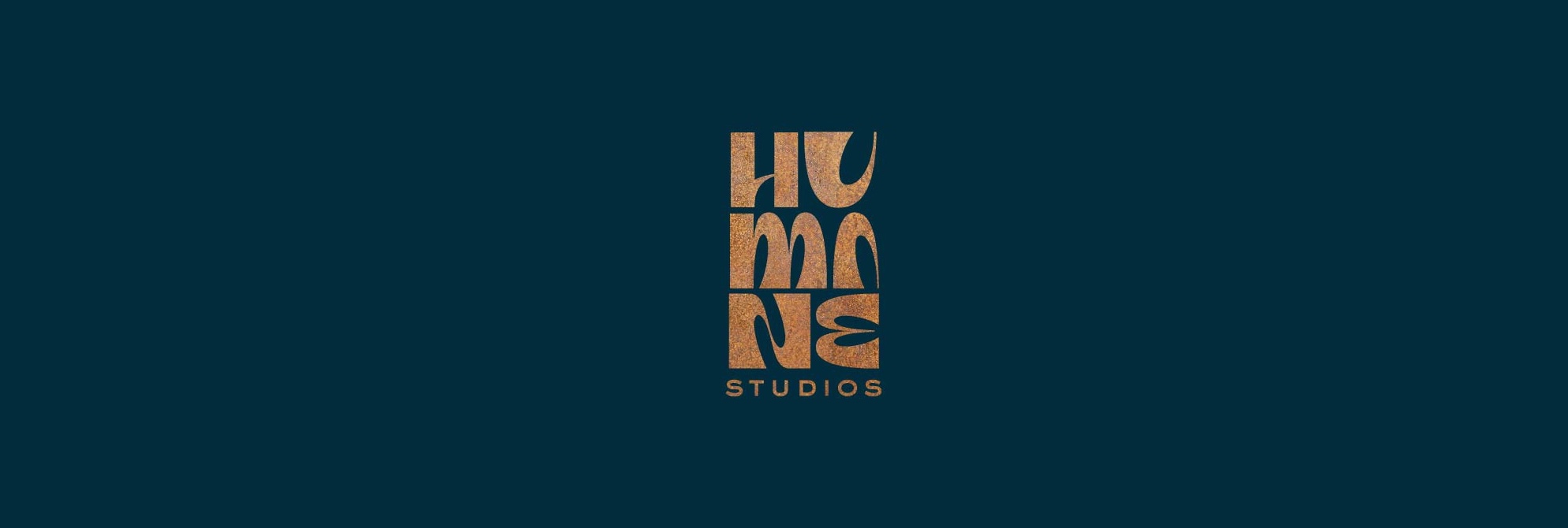 text logo for humane studios in navy and gold