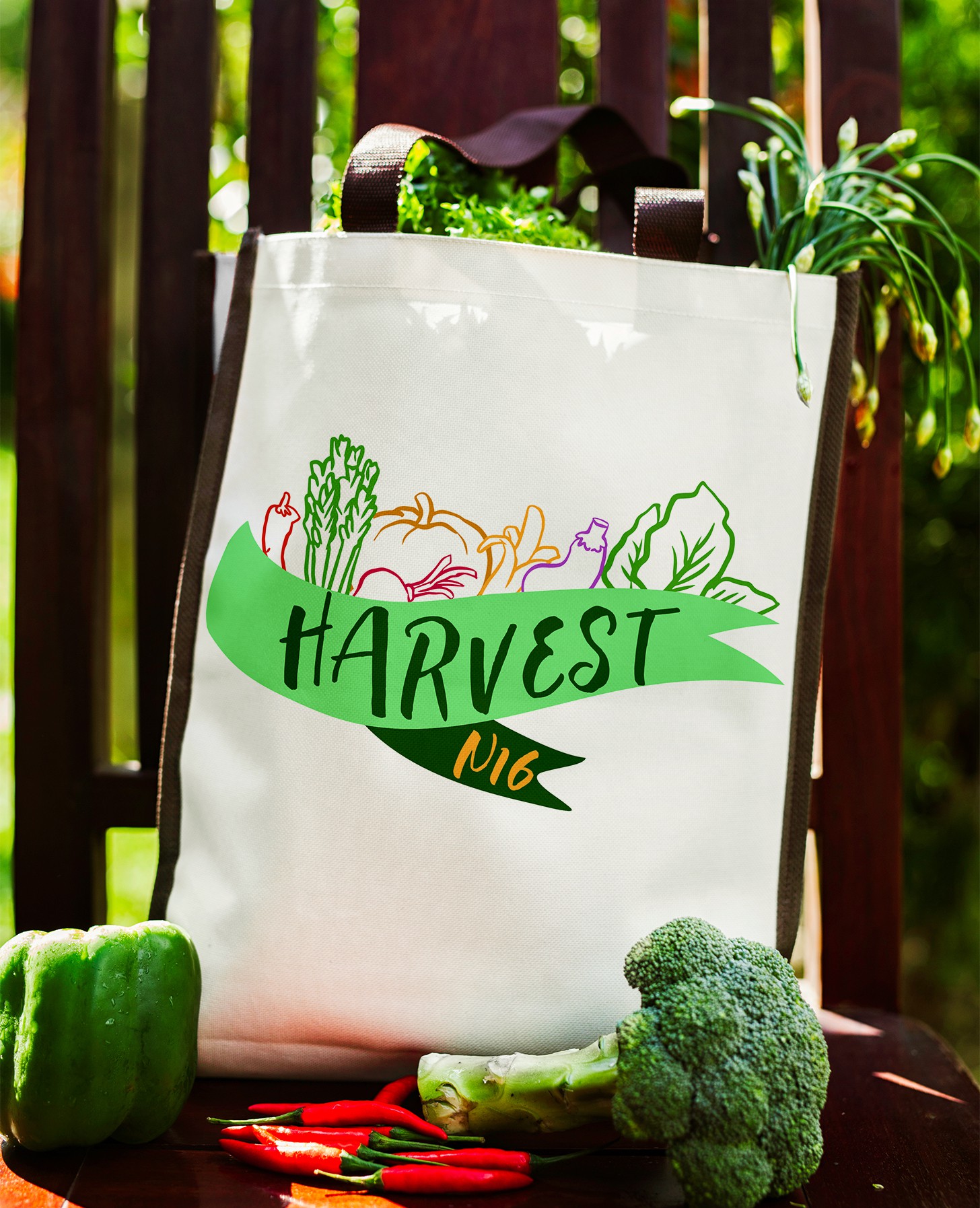 canvas tote bag featuring a logo and colorful outlines of vegetables