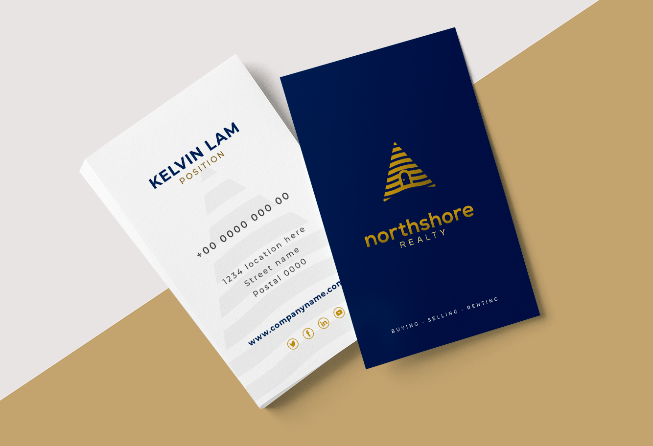 Blue and gold business card design for a real estate company