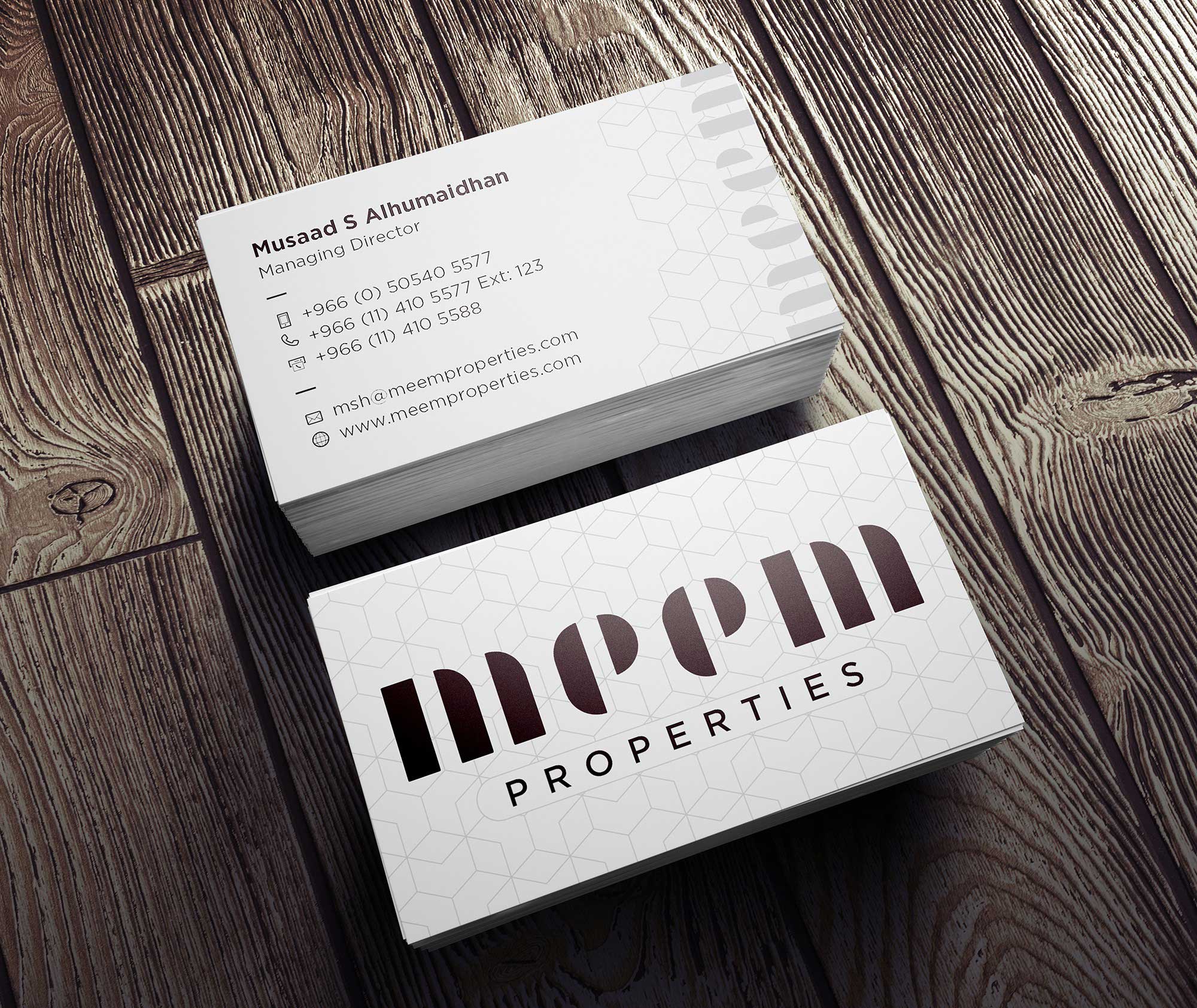 Real estate business card design with oversized wordmark