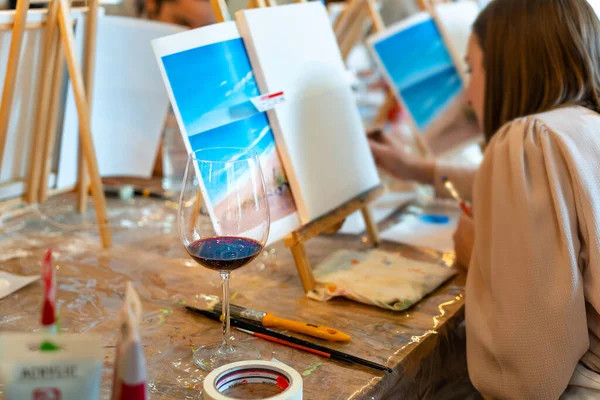 creative corporate event ideas - woman painting on a tabletop easel