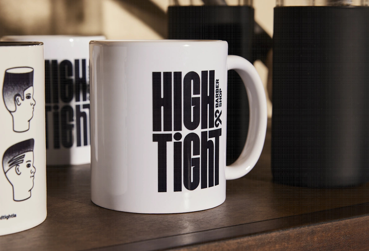 Black-and-white branded ceramic mug for a barbershop with the logo printed on it using the dye sublimation logo printing technique