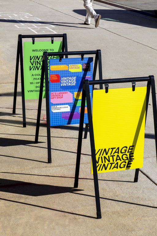 Three brightly colored metal A-frame signs.