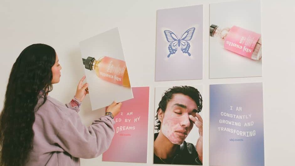 woman putting up beauty cosmetic company posters