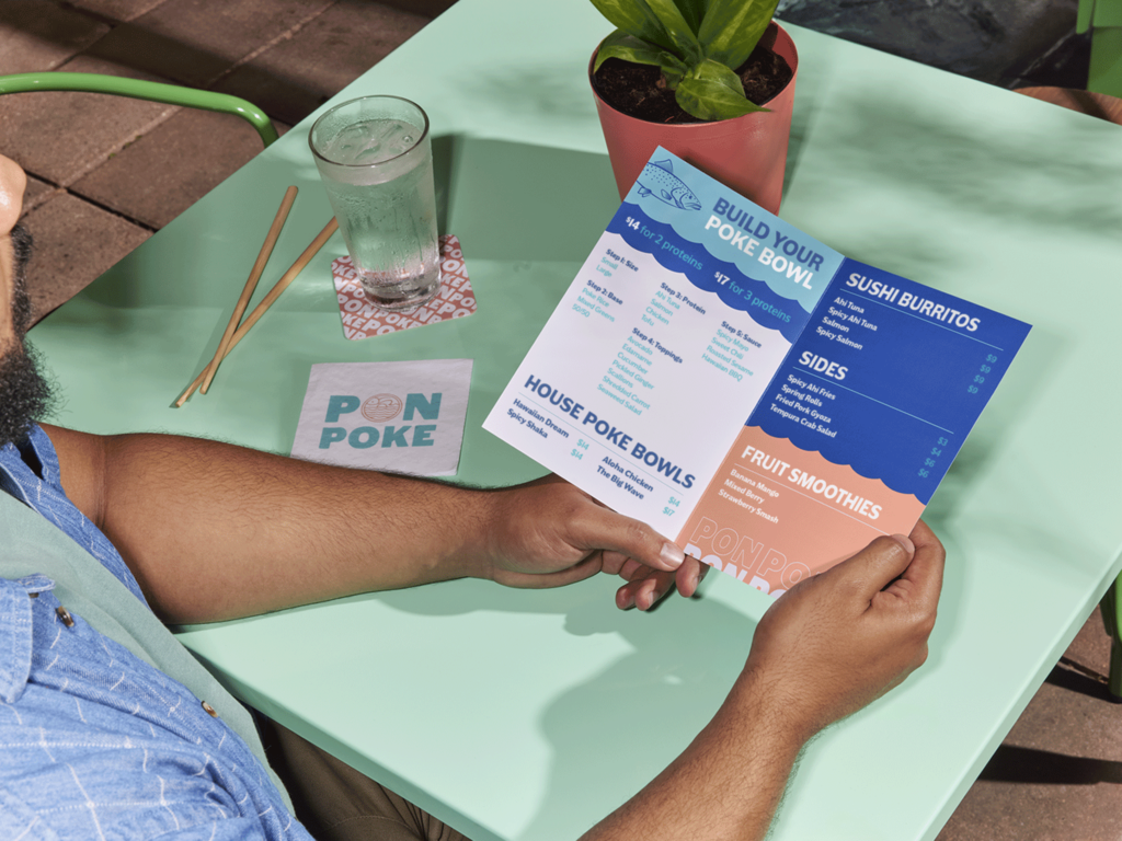 Blue and white branded folding menus for a poke restaurant