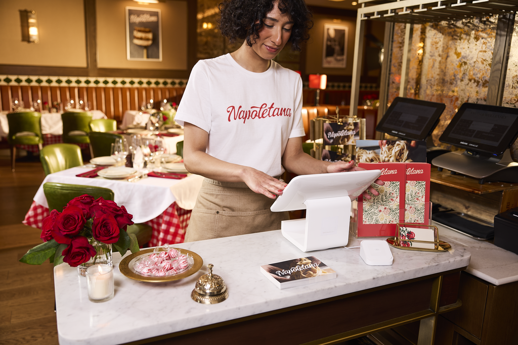 A restaurant employee wearing a branded T-Shirt