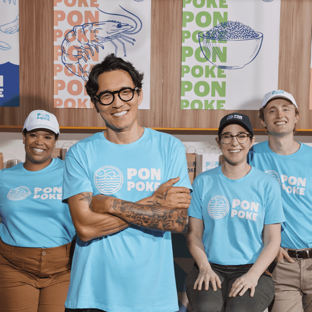 oke restaurant team wearing branded logo T-shirts and smiling