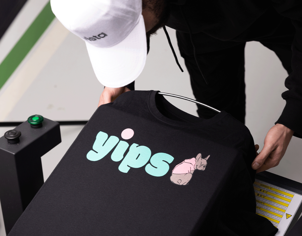 A sheet being peeled off a black T-shirt with bright print design