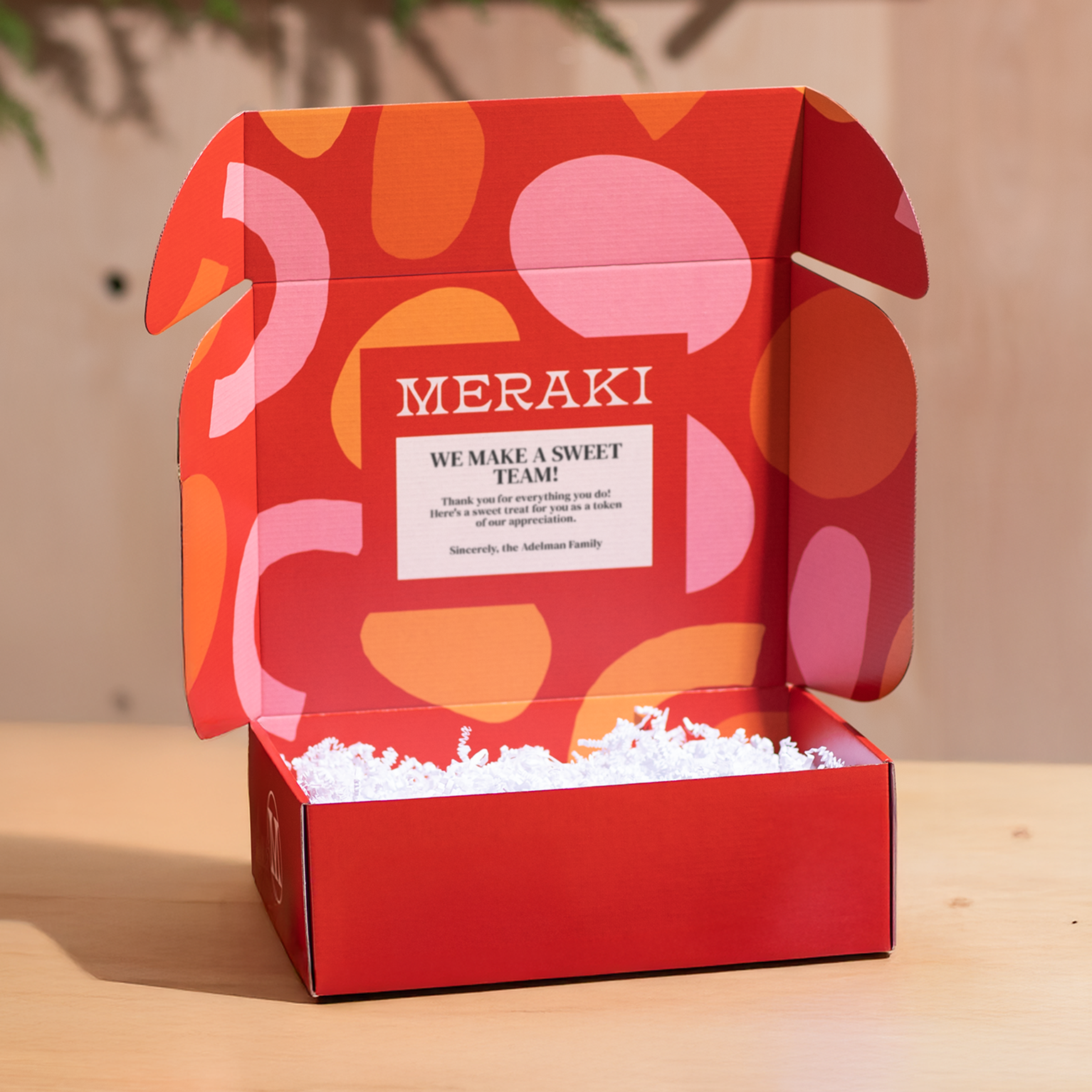 Open red custom branded box with orange and pink graphics and thank you message printed on inner top panel