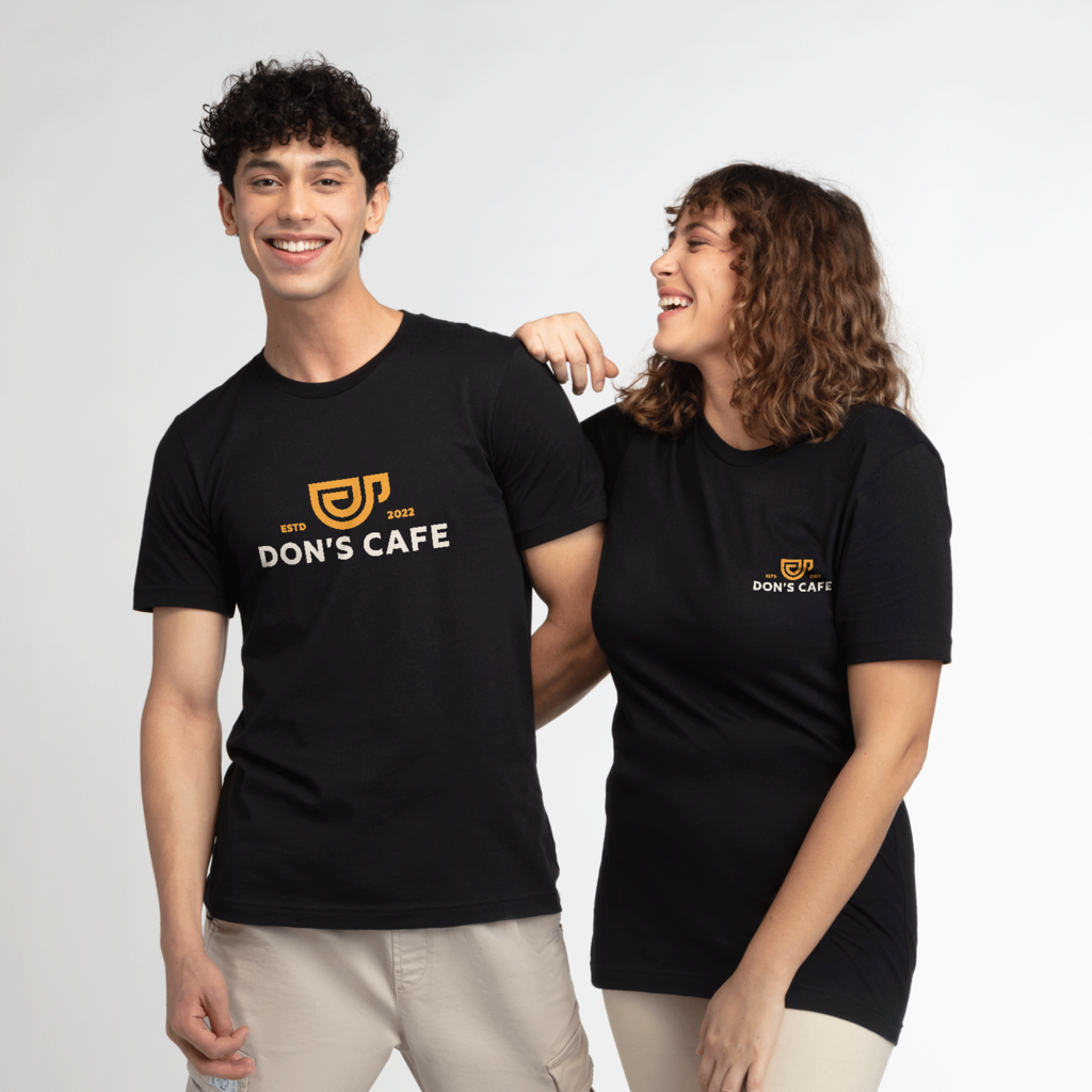 Cafe employees wearing T-shirts with different design placements: left chest and full chest