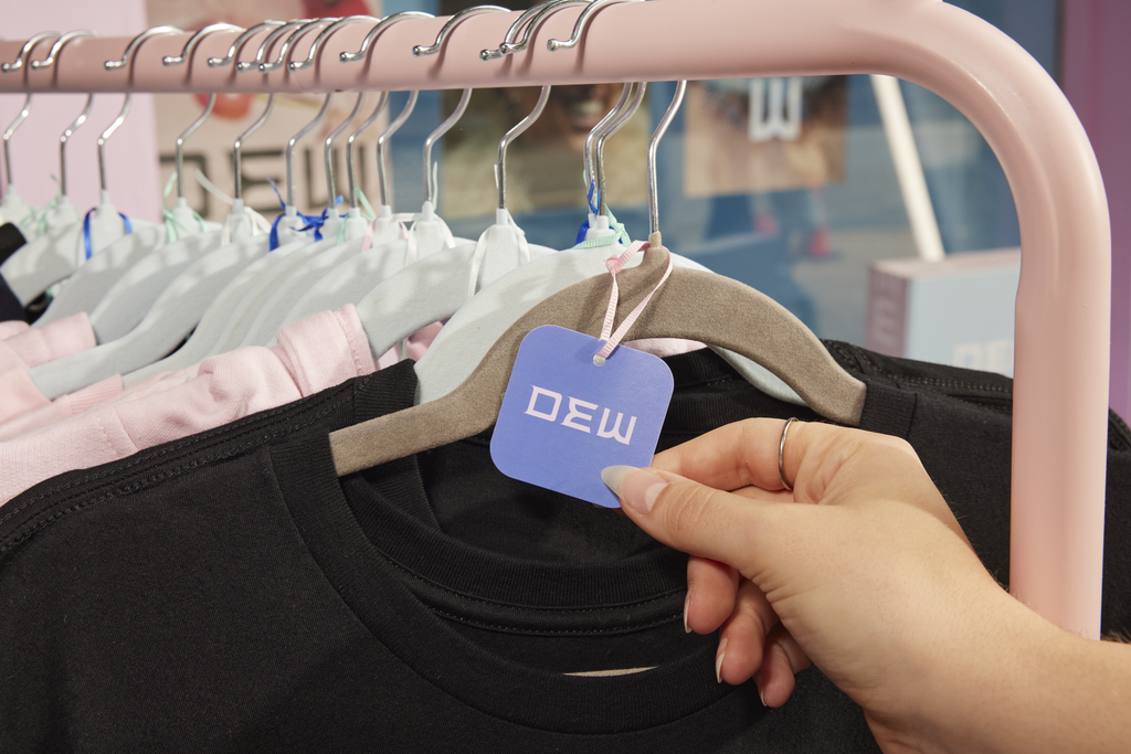 Purple clothing tag for a black T-shirt with a brand logo