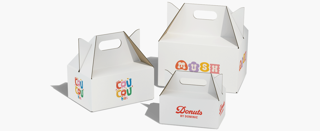 Three white branded carry boxes in different sizes with handles