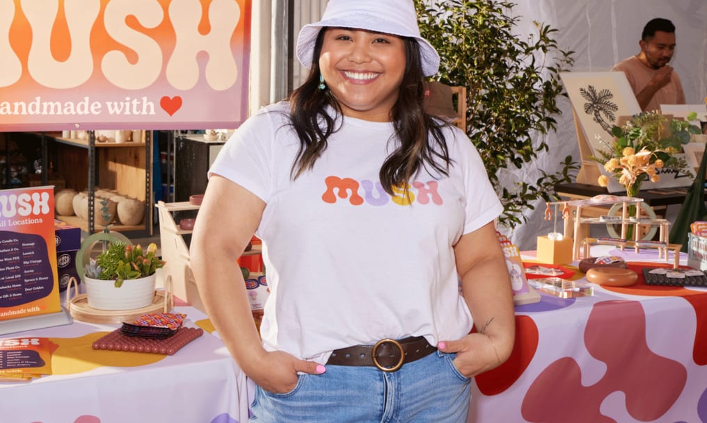 A person wearing a branded T-shirt for product marketing.