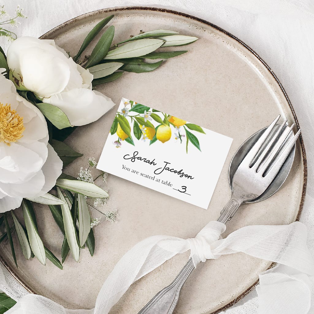 white place card featuring a colorful floral design at the top