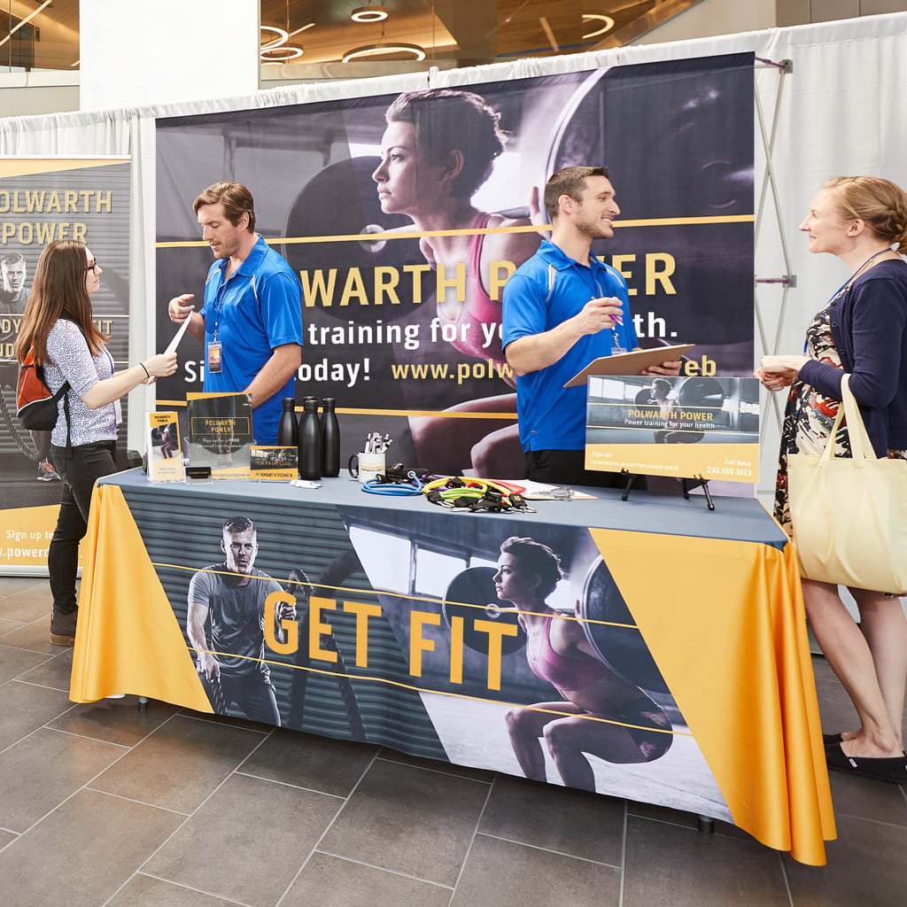 Business staff engaging with trade show visitors at the event
