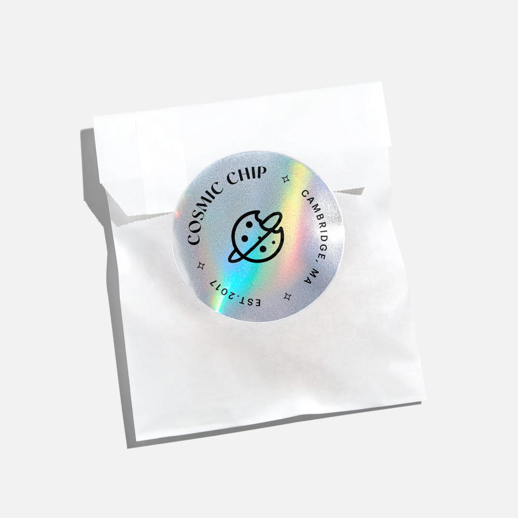 Branded sticker with a holographic finish used to seal a paper bag