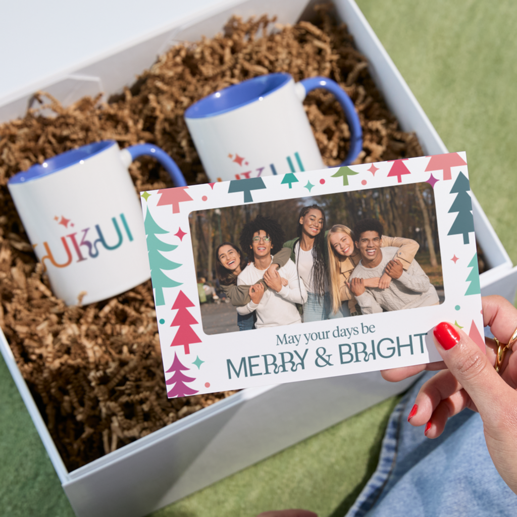 Branded mugs in a holiday gift basket with a customized note