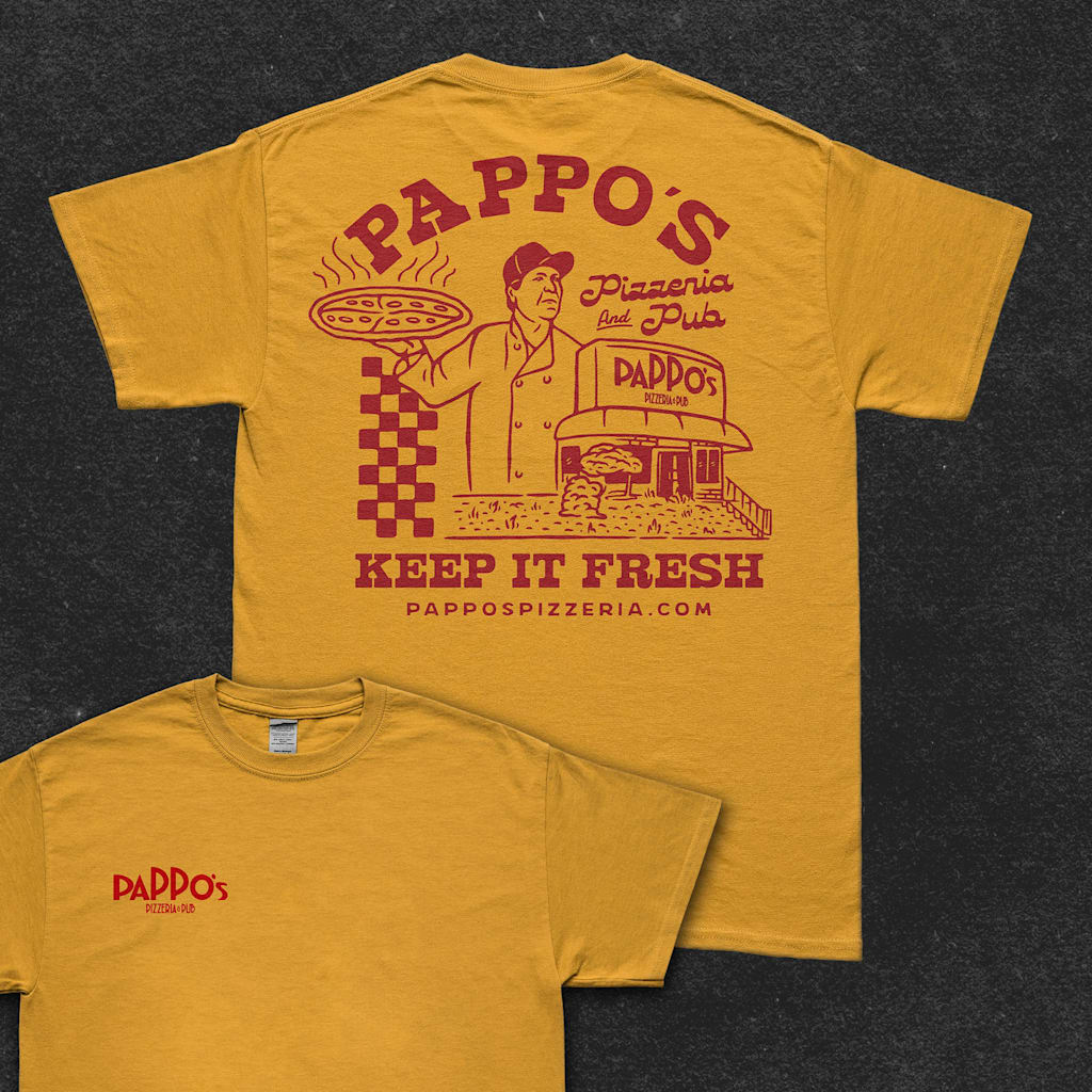 Yellow T-shirt with red graphic of man holding pizza and pizza restaurant with font &ldquo;PAPPO&rsquo;s Pizzeria and Pub, KEEP IT FRESH.&rdquo;