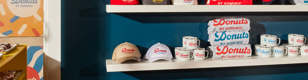 A store shelf displaying branded merchandise like caps and mugs for sale