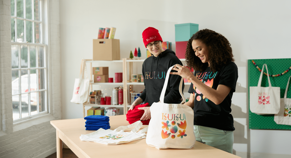 Employee wearing and packing branded beanies