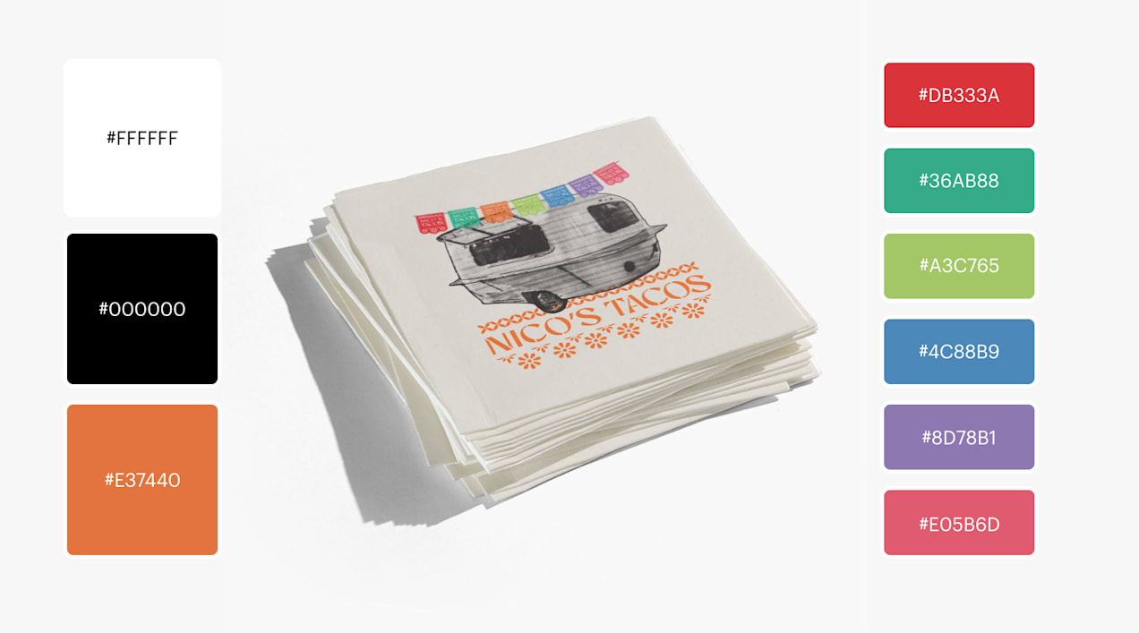 A food truck logo printed on napkins features a black-and-white taco trailer with a rainbow colored garland of papel picado.