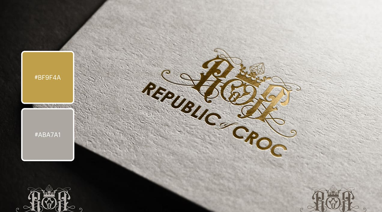 An regal logotype that resembles a monogram with filigree in gold on grey premium paperstock