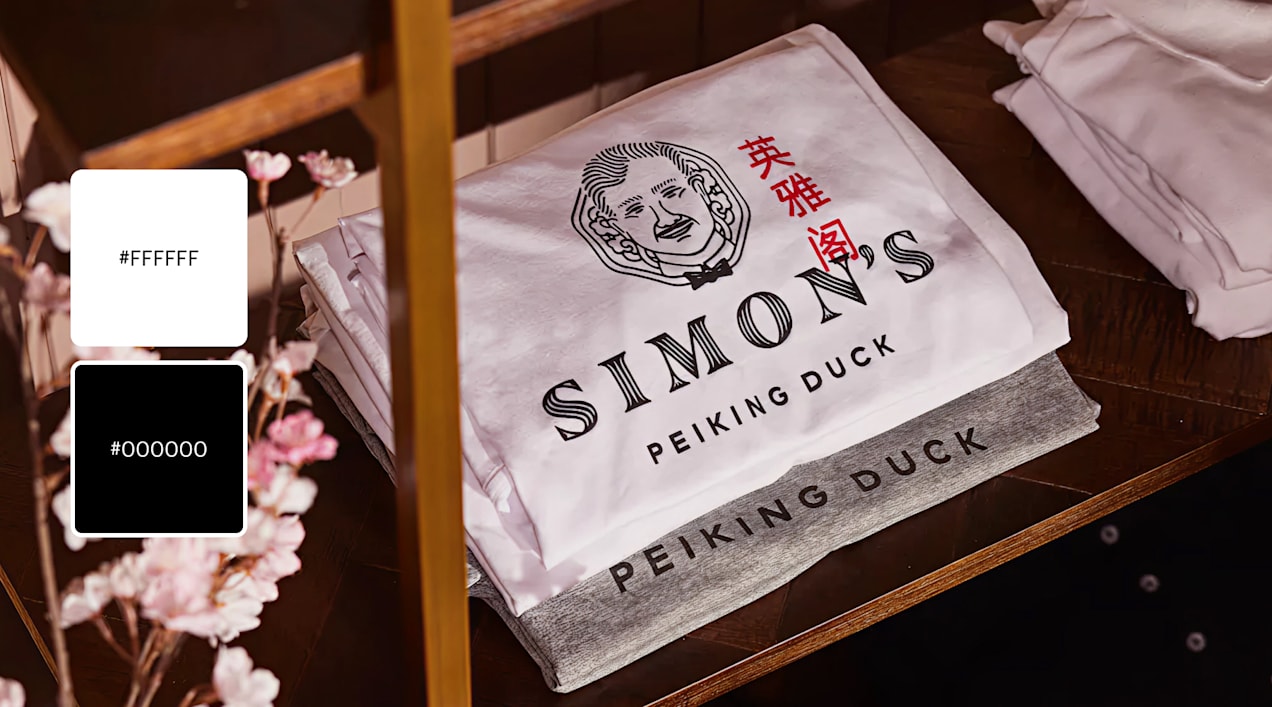 A black and white logo for Simon’s Peking Duck with a phrase in Chinese accented in red