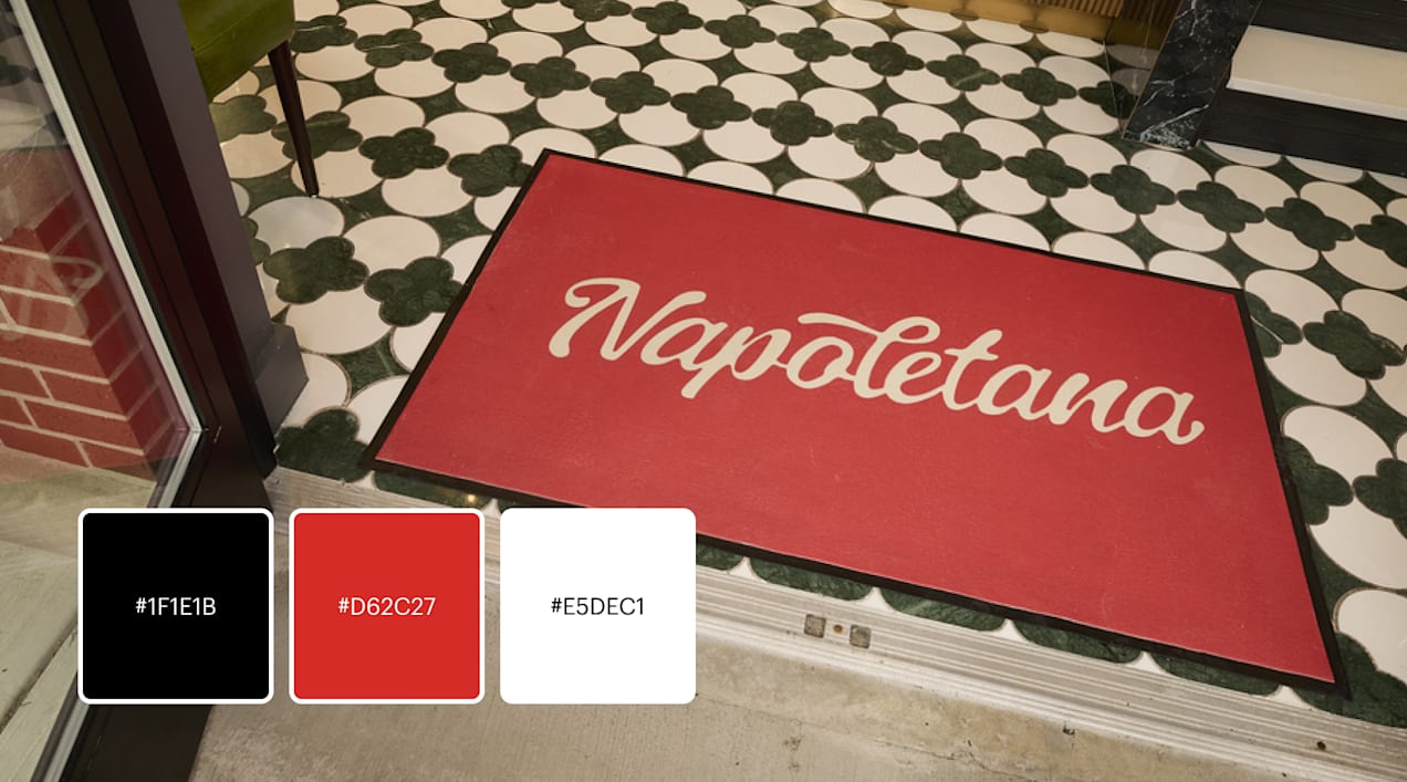 A red and white logo with branded placement over black and white tiles for a italian restaurant