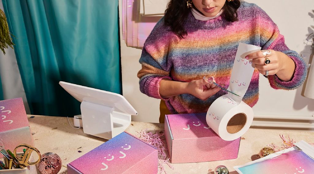 A small business owner with custom packaging