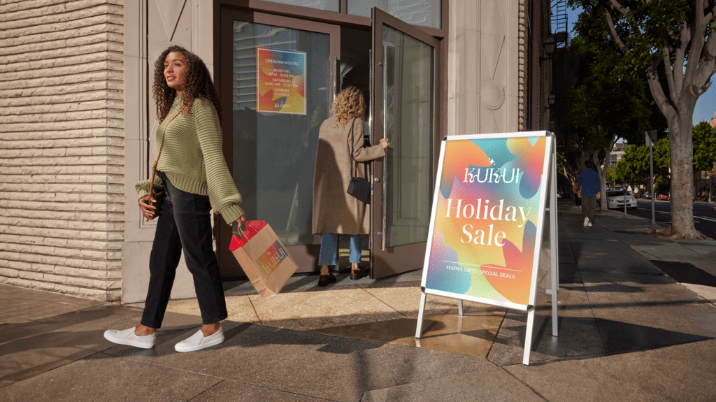 Aluminum A-frame outdoor retail store signage using brand fonts