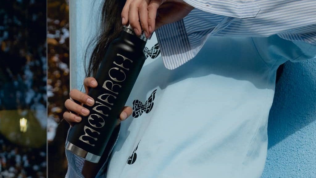 A woman holding a branded water bottle