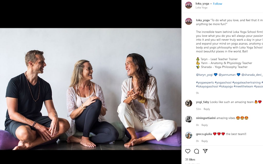 A man and two women are sharing a conversation while sitting on the floor