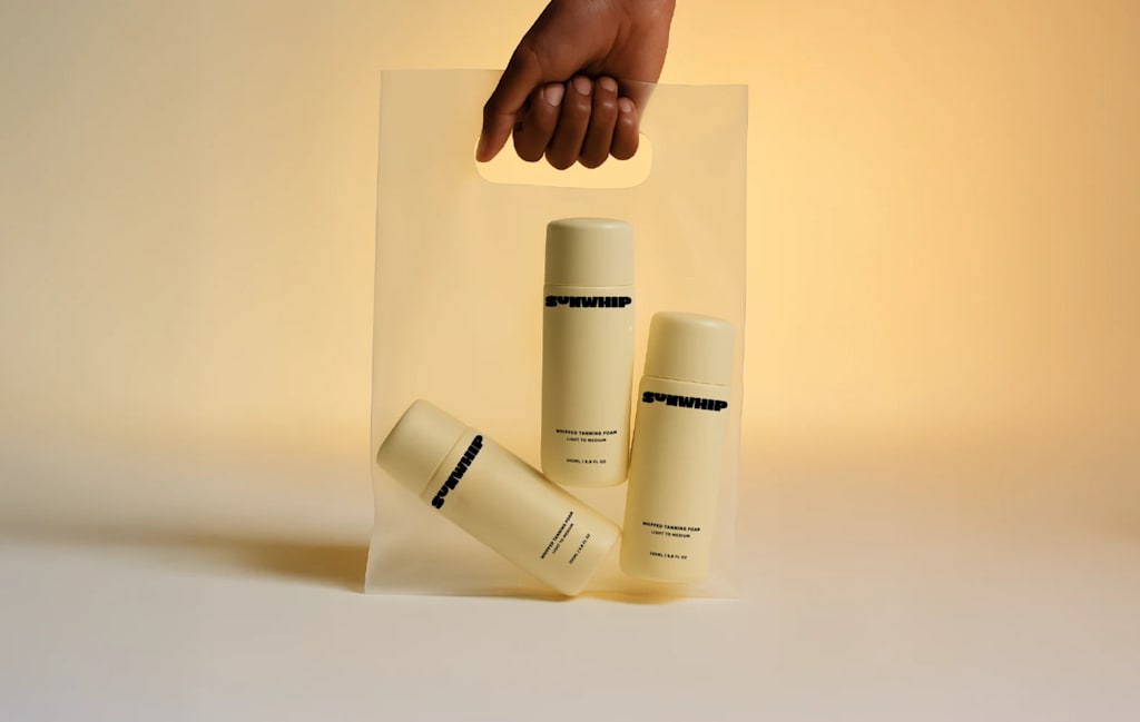 Example of the color trends 2026 Banana Yellow with a hand holding a transparent bag filled with three cosmetics bottles in pastel yellow