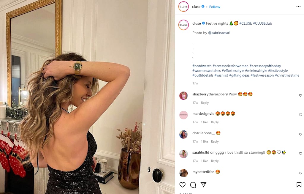 A woman in a black dress shows off her new watch