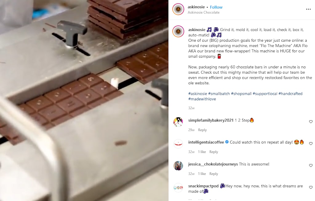 A stack of chocolate bars are processed by a machine