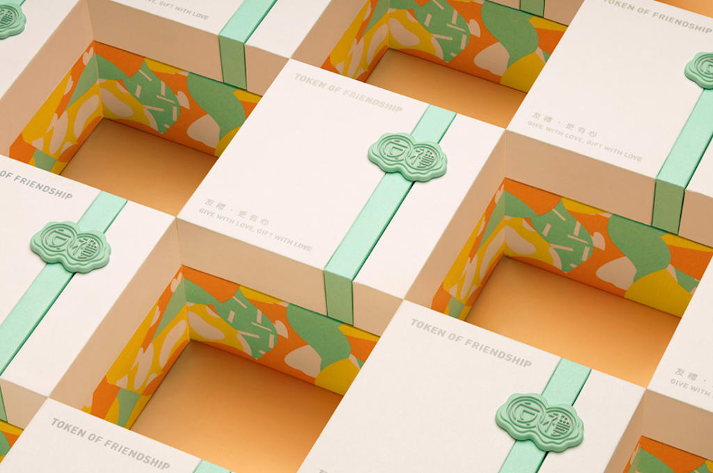 open yellow, white and green box, showing a gold necklace