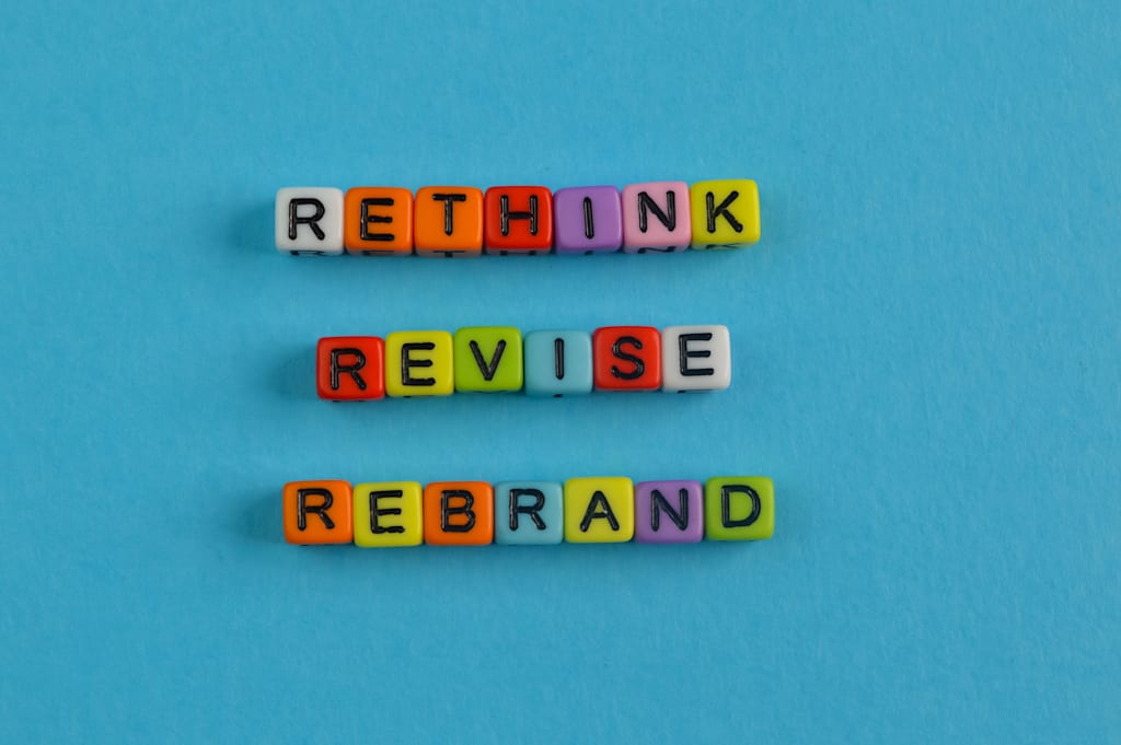colorful beads spelling out &lsquo;rethink revise rebrand&rsquo;
