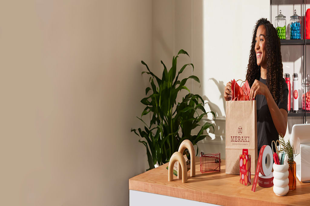 Manager shakes hand and congratulating an employee.