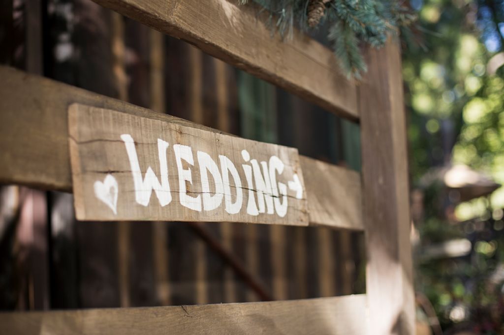 Rustic gate with "wedding" scrawled on in chalk