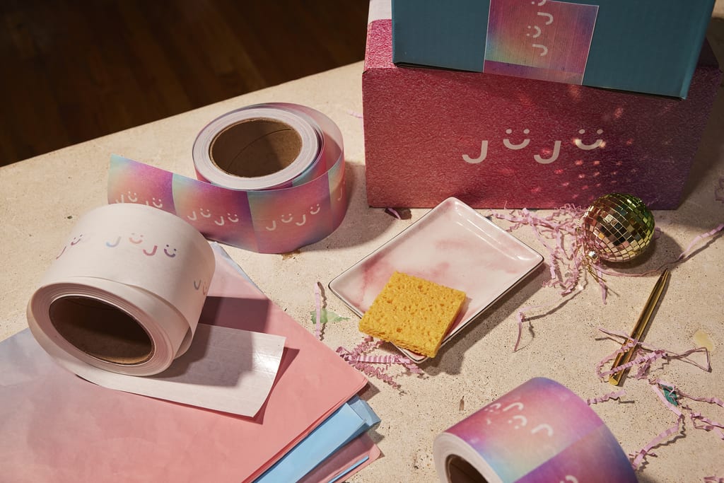 Holiday packaging with branded wrapping paper and ribbon