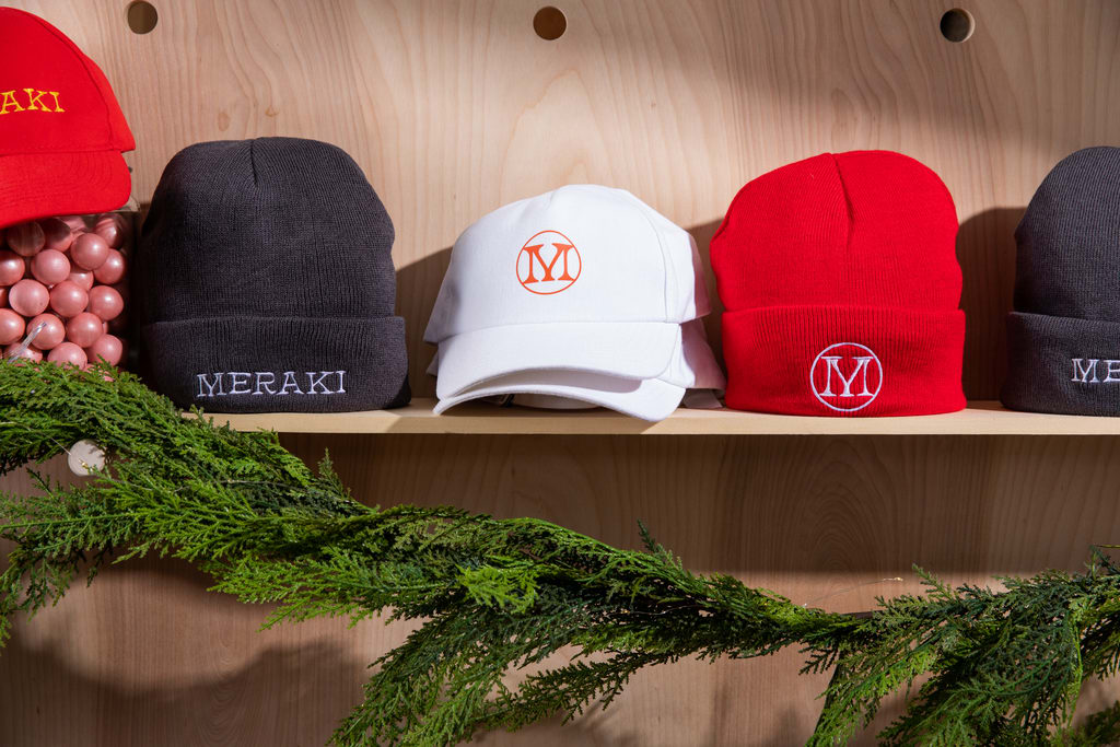 Red, white and gray branded hats for a holiday giveaway