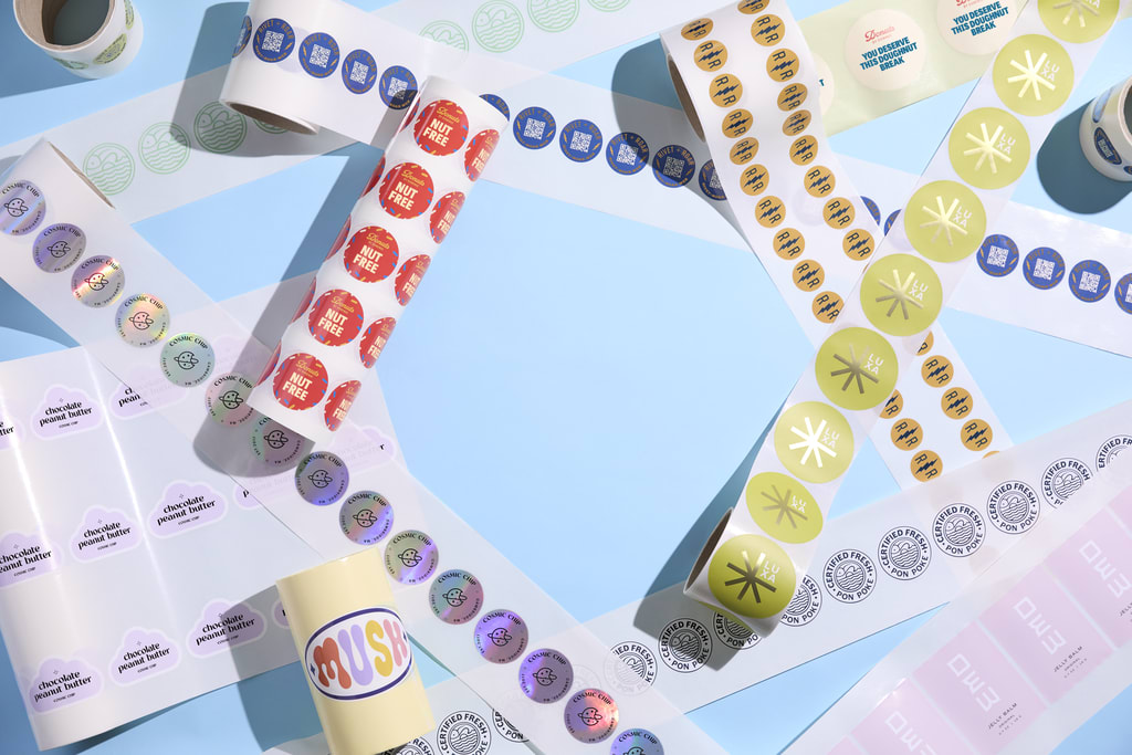 Various sticker rolls with brand logos of different brands