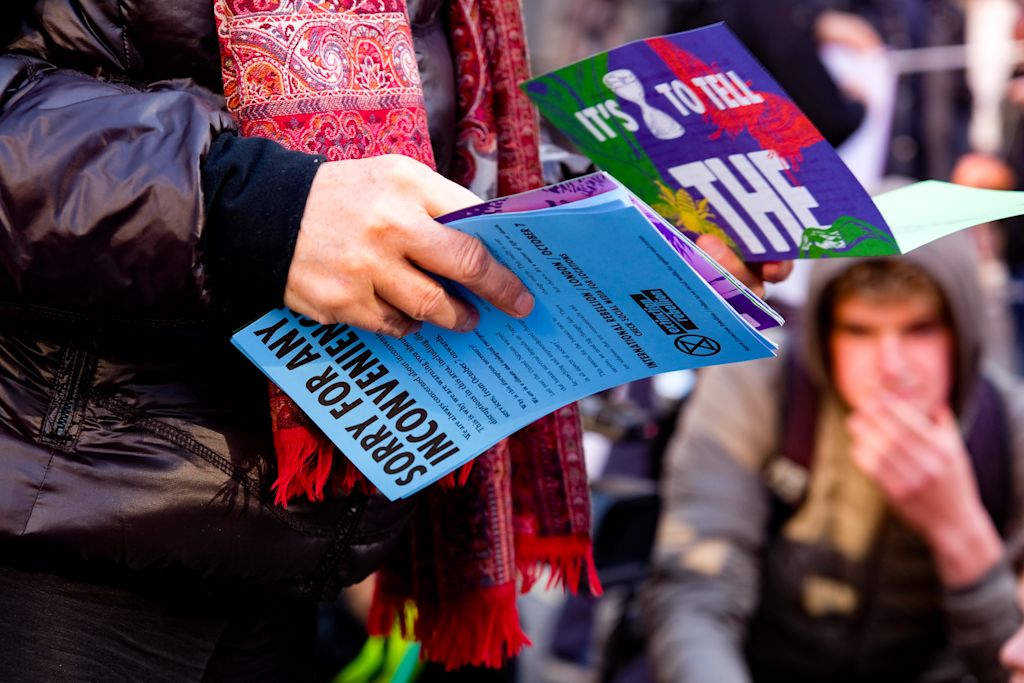 Mid-shot of person holding assortment of colorful flyers.
