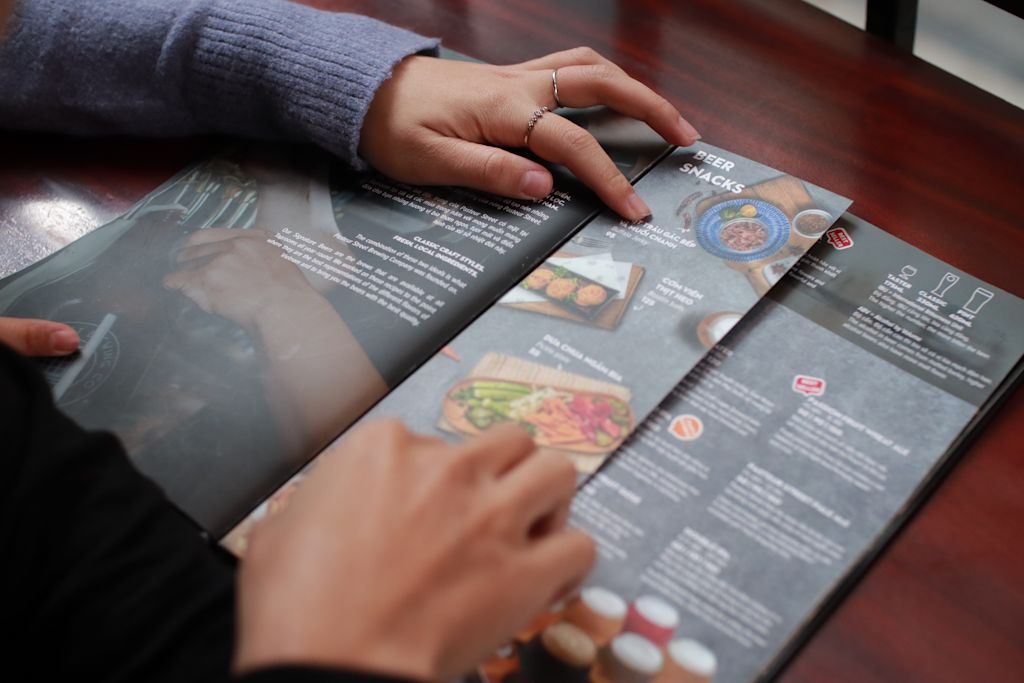 Close0up of takeaway menu with person’s hands in shot.